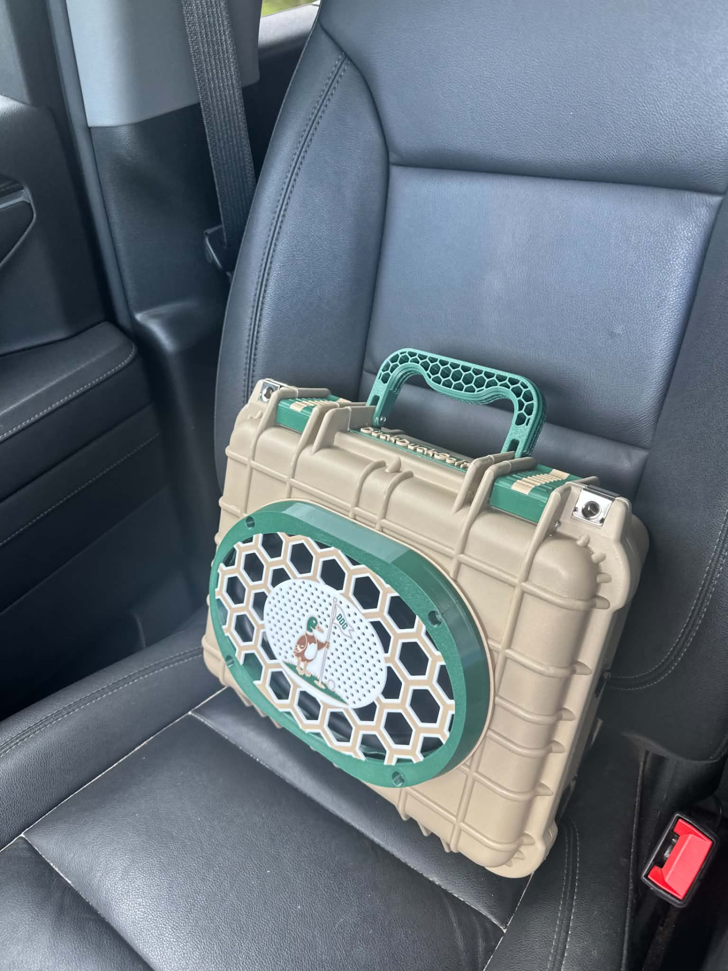 Tan rugged custom speaker box with green honeycomb grille and handle
